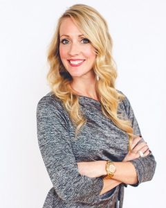 Smiling woman with long blonde hair and a stylish gray top, representing Refined Lending, promoting mortgage refinancing and rate alert notifications.