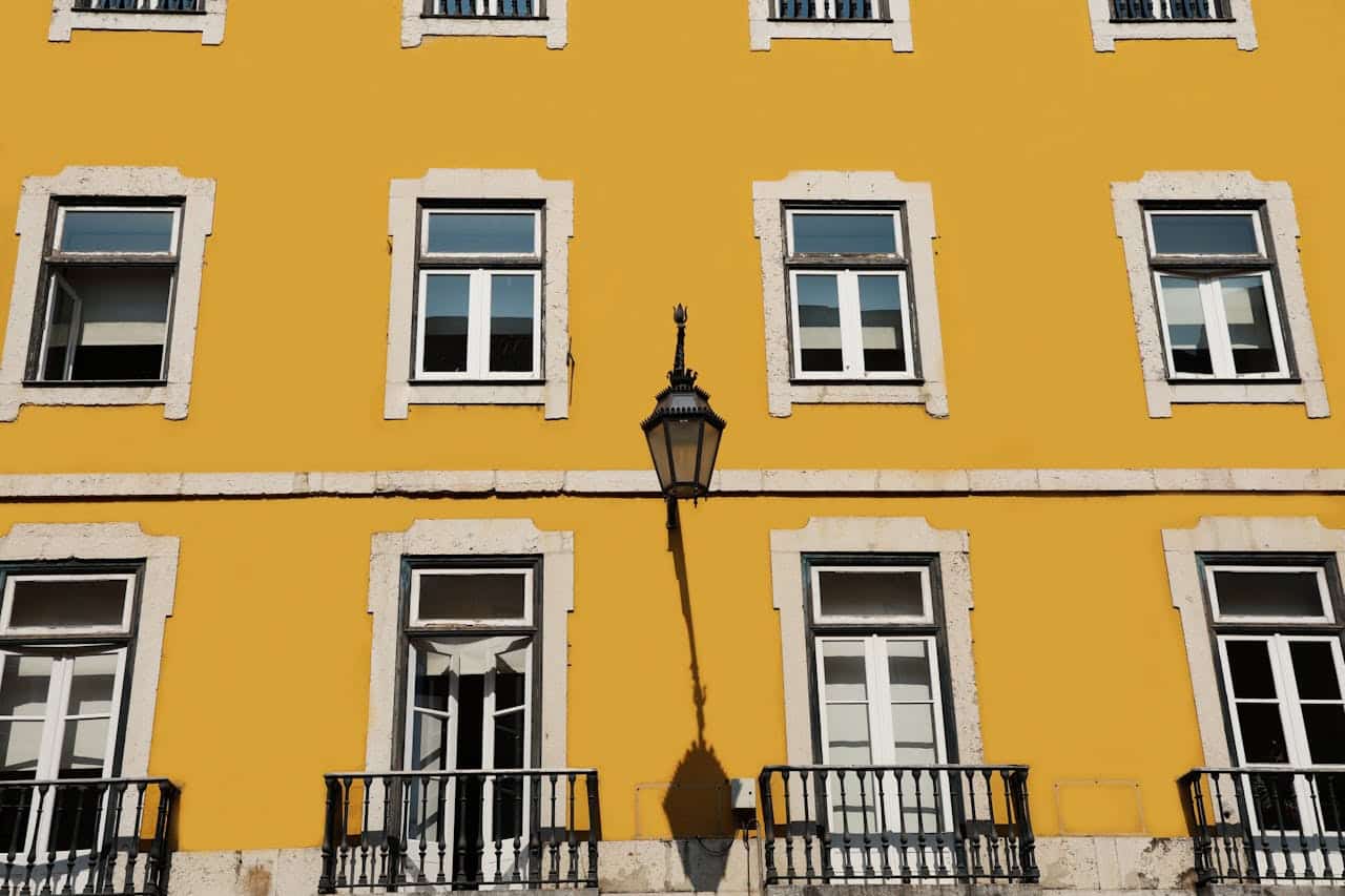 Yellow building facade with multiple windows and a decorative street lamp, representing home aesthetics and potential cash-out refinancing options for homeowners in Minnesota.